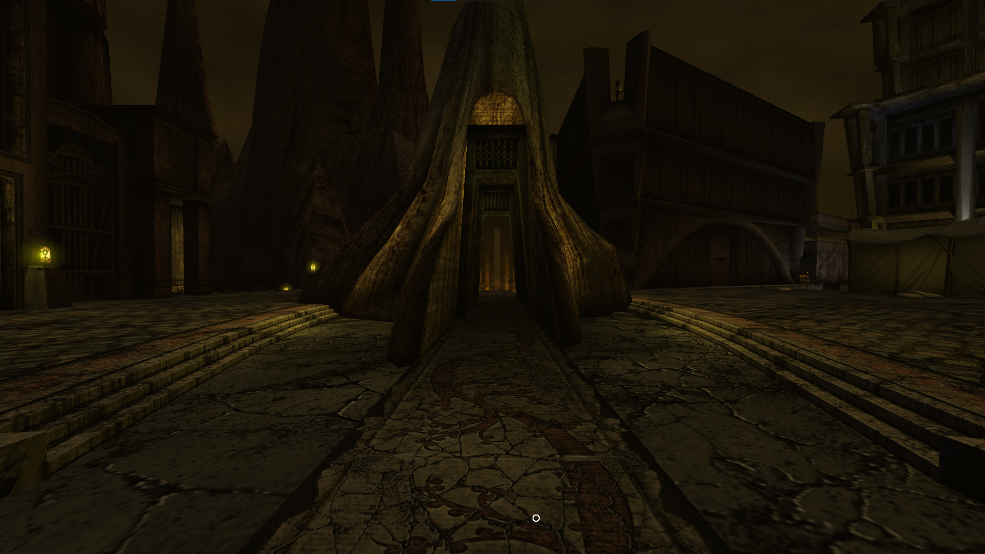 Screenshot of Uru showing the Ae'gura hub area: a courtyard with a large tree stump (I think) with an arch cut out of it framing a larger arch in the distance.